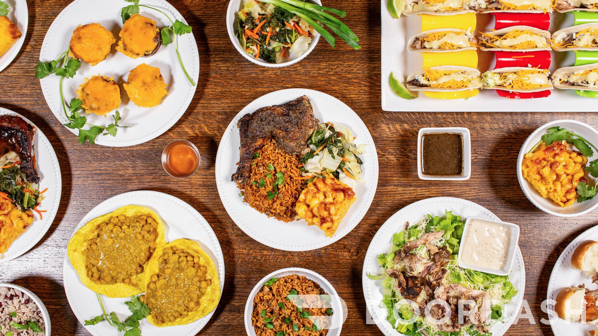 Island Eleven Caribbean food spread on a table